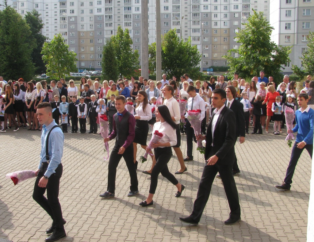 On the first day at school students bring flowers to greet their teachers. 